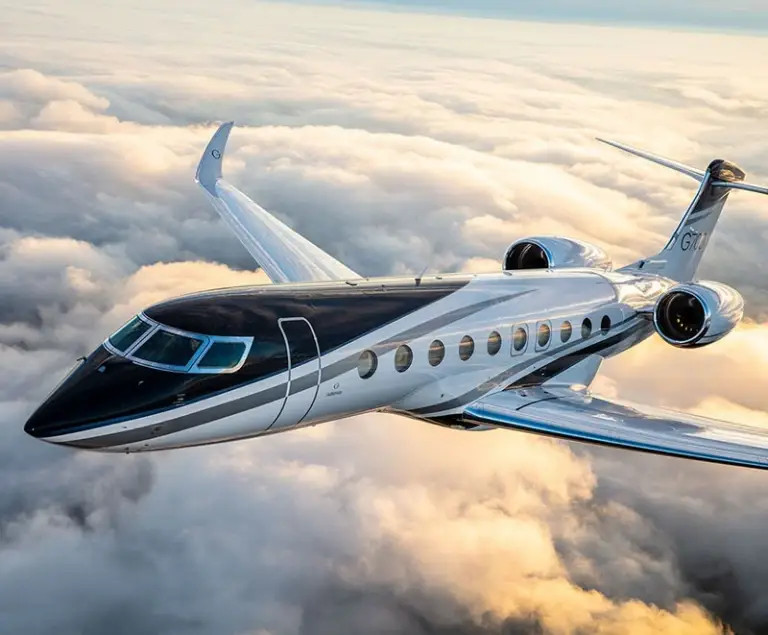 Gulfstream private jet flying above the clouds